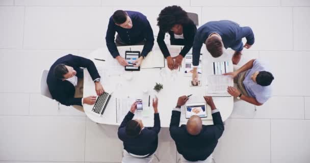 Lets call it a deal then. High angle 4k video footage of a group of businesspeople having a meeting together around a table at work during the day. — Vídeos de Stock