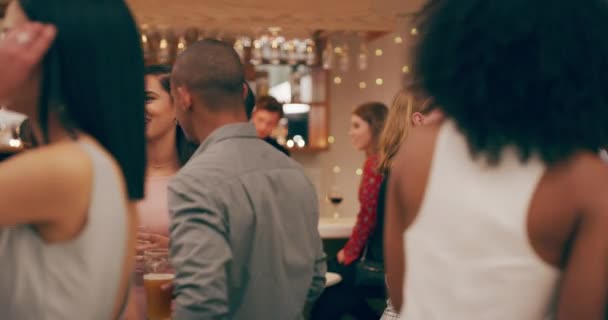 Confidence gets you noticed in a good way. 4k video footage of a group of young people having drinks and socialising at a party. — Vídeo de stock