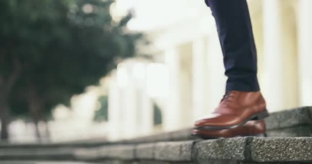 Take the step. 4k video footage of an unrecognizable businessman walking in the city. — Video