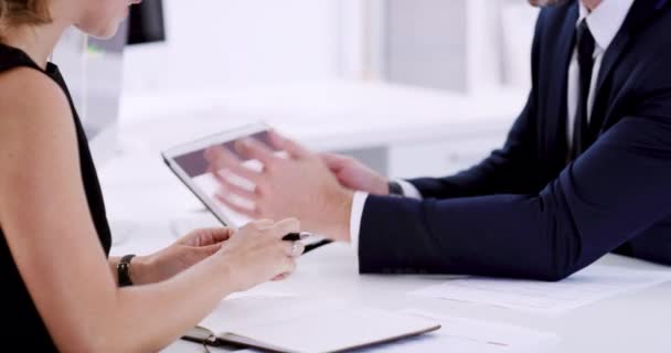 This is the figure we need to work with. 4k video footage of two unrecognizable business colleagues sitting in the office together and using a tablet during a discussion. — Wideo stockowe