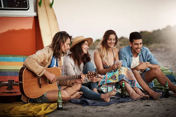 The best of friends always have the best of times. Cropped shot of a group of friends hanging out together on the beach. — Stock Photo, Image