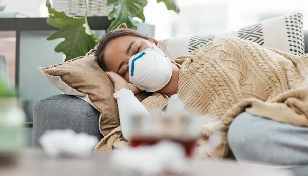 Ihr Körper braucht den Rest, den er bekommen kann. Aufnahme einer Frau mit Maske, während sie krank zu Hause liegt. — Stockfoto