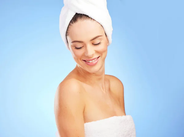 Nothing better than feeling refreshed. Shot of a young woman in a towel against a blue background. — Stock Photo, Image