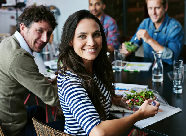 Comer de forma saudável mantém-na viva o dia útil. Retrato de um jovem funcionário de escritório almoçando com colegas de trabalho em uma mesa de reuniões. — Fotografia de Stock