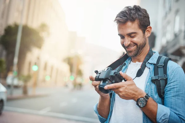 What fills the passport fills the heart. Cropped shot of a young man taking photos while exploring a foreign city. — Stock Photo, Image