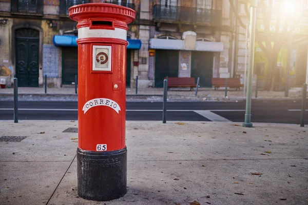 Hes hungry and wants some mail to eat. Shot of a red mailbox standing on its own in the city outside during the day. — Stock Photo, Image