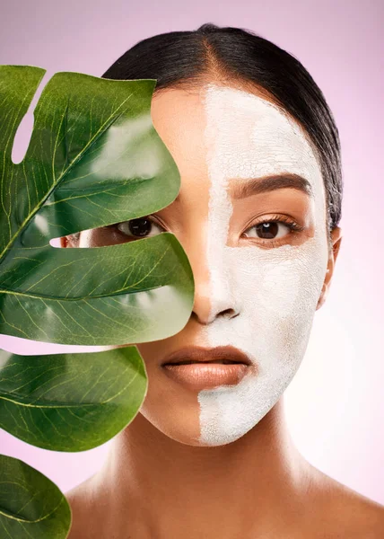 Mother Nature makes my beauty products. Studio shot of an attractive young woman holding a plant and having a facial against a pink background. — Stock Photo, Image