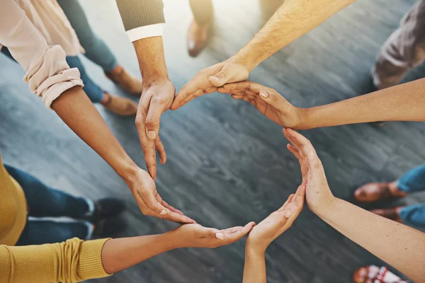 Were all in it to make a success. High angle shot of a group of unidentifiable businesspeople forming a circle with their hands. — Stock Photo, Image