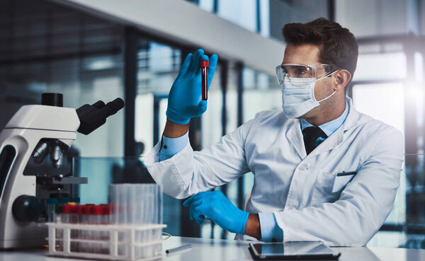 This could be the cure. Cropped shot of a young male scientist working in a lab.