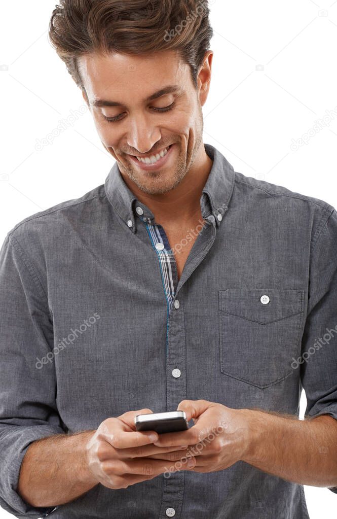 Texting a friend. A handsome young man sending a text message.