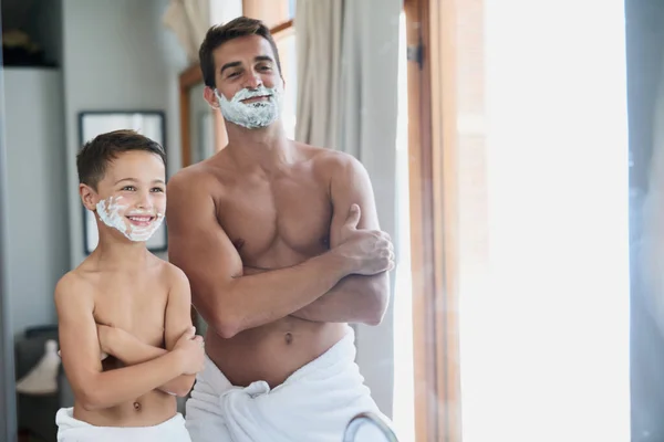 Cool, yo. Cropped shot of a handsome young man teaching his son how to shave in the bathroom. — Stock Photo, Image