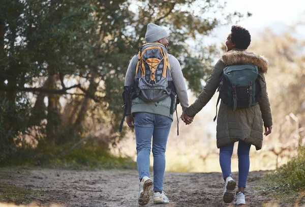 Time to stretch our legs. Shot of a young couple going for a hike during a camping trip. — Stock Photo, Image