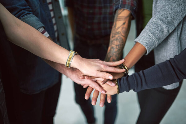 Hands in, everyone. Cropped shot of a group of people stacking their hands on top of each other.