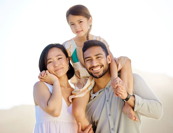 Вона наша гордість і радість. Обрізаний знімок щасливої різноманітної сім'ї з трьох на пляжі . — стокове фото