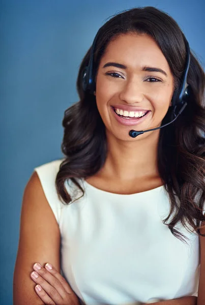 Its all about confidence. Studio portrait of a confident young woman posing against a blue background.