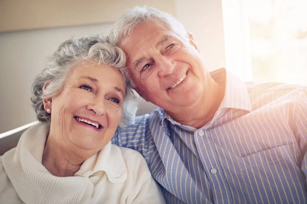 Reminiscing on all their wonderful experiences together. Cropped shot of a senior couple looking thoughtful at home. — Stock Photo, Image