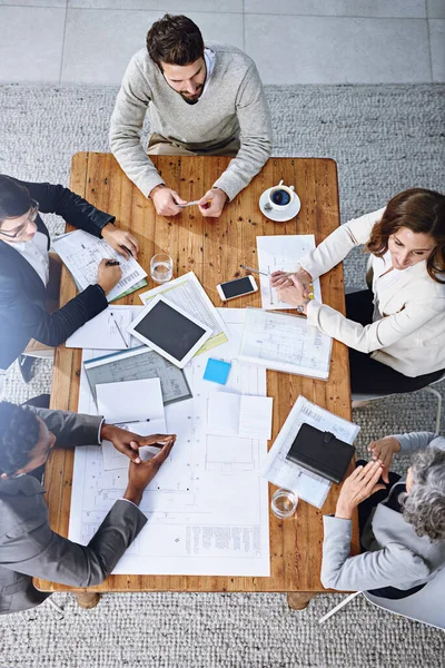Sono una squadra allineata al successo. Foto ad alto angolo di un gruppo di uomini d'affari che si incontrano in un ufficio. — Foto Stock