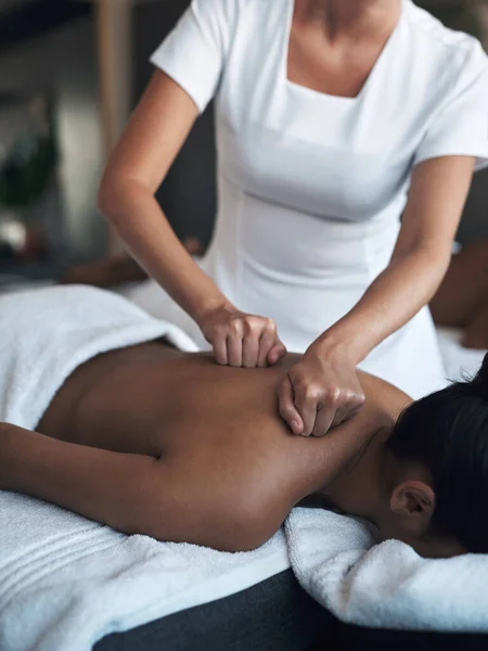 Utarbeta spänningen i dessa tryckpunkter. Skjuten av en ung kvinna som får ryggmassage på ett spa. — Stockfoto