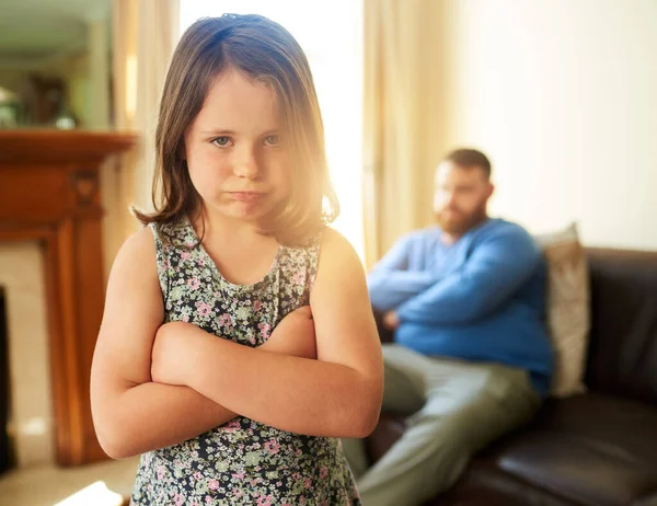 Its all fun and games until Dad says no. Shot of an unhappy little girl sulking after a disagreement with her father. — Stock Photo, Image