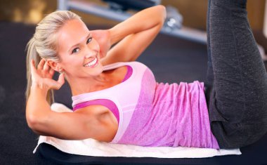Call me for your exercise routine. Portrait of an attractive young woman doing sit ups. clipart