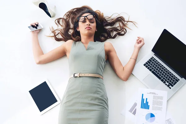 Shes done. High angle shot of a young businesswoman lying on her office floor. — Stock Photo, Image