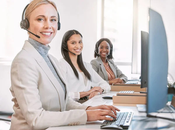 Weve got all the answers. Cropped portrait of an attractive mature female call center agent wearing a headset while working in the office with her coworkers. — Stock Photo, Image