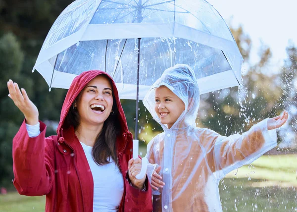 A mãe torna tudo divertido. Tiro de uma mãe brincando na chuva com sua filha. — Fotografia de Stock