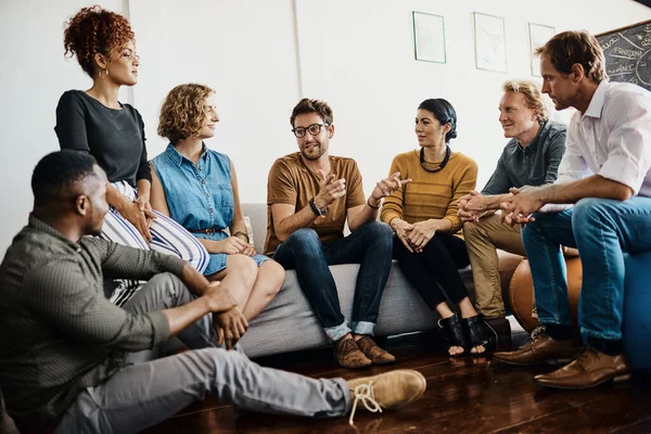 They boast a dynamic range of talents. Shot of a group of designers having a discussion in an office. — Stock Photo, Image