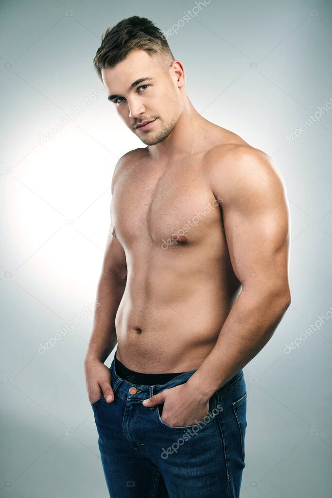See what an active lifestyle could do for you. Studio shot of a handsome young man posing shirtless against a grey background.