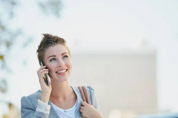 Te llamaré una vez que vuelva a la oficina. Recorte de una joven mujer de negocios hablando en su teléfono celular mientras estaba en la ciudad. — Foto de Stock