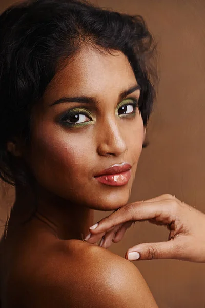 Shes all natural. Studio shot of a beautiful young woman against a brown background. — Stock Photo, Image