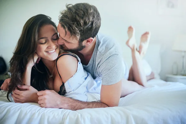 Está calor aqui ou és só tu. Tiro de um casal afetuoso deitado em sua cama. — Fotografia de Stock