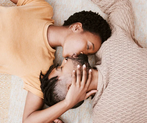 Every kiss is like the first. Aerial shot of a young couple kissing at home. — Stock Photo, Image