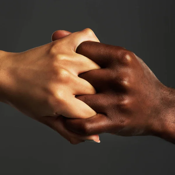 Estaban unidos para siempre. Estudio de dos personas irreconocibles sosteniendo sus manos juntas sobre un fondo gris. — Foto de Stock