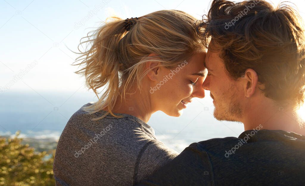 Silence speaks a thousand words. Shot of a loving couple sitting on a bench overlooking the ocean.