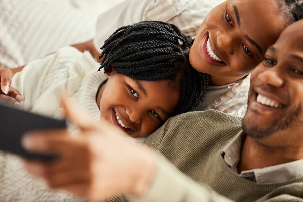 Making memories one selfie at a time. Shot of a young family taking a selfie at home. — Stock Photo, Image