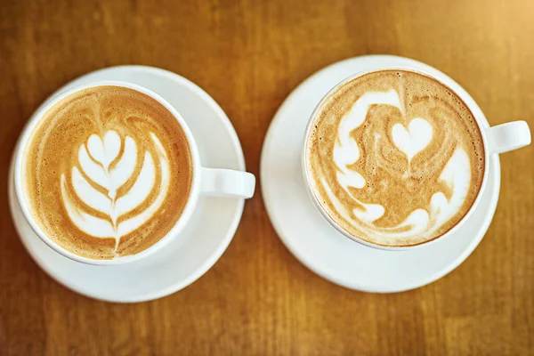 The perfect pair. Shot of a coffee cup in a cafe. — Stock Photo, Image