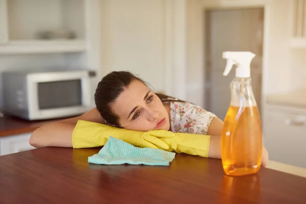 Hay demasiadas tareas que hacer. Tiro de una mujer joven de aspecto cansado apoyado en una encimera de cocina. — Foto de Stock