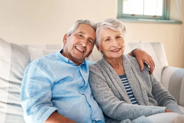 Vivemos bem quando amamos muito. Tiro de um casal de idosos relaxando juntos no sofá em casa. — Fotografia de Stock