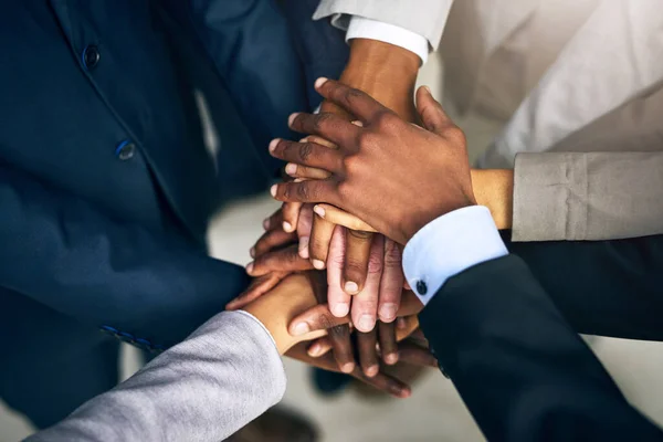 Bring it in, team. High angle shot of a group of unrecognizable businesspeople joining their hands together in unity. — Stock Photo, Image