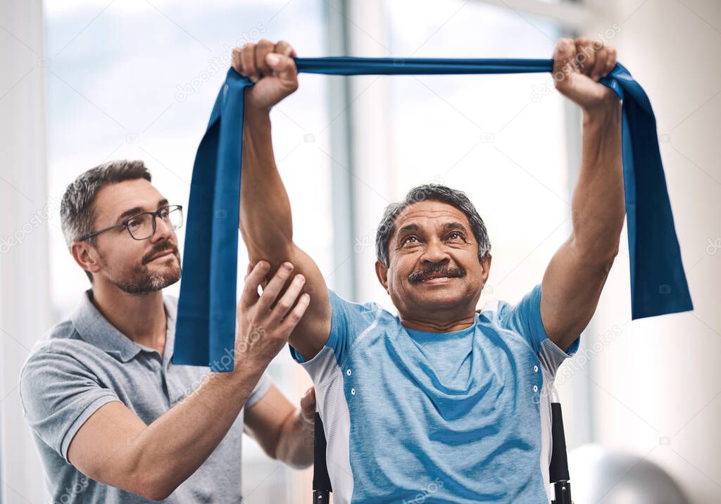 Shot of a senior man exercising with a resistance band during a rehabilitation session with his physiotherapist.