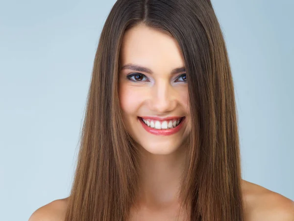 stock image Studio portrait of a beautiful young woman posing against a blue background