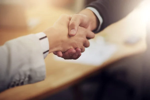 Cropped shot of two businesspeople shaking hands.