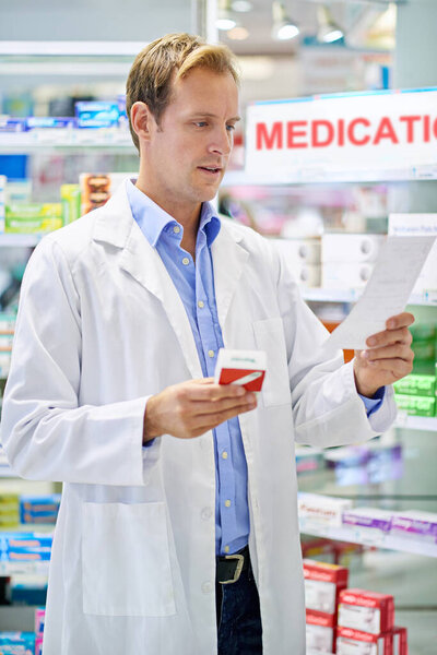 A pharmacist reading a prescription.