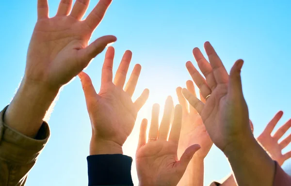 Cropped shot of a group of unrecognizable peoples hands outside.