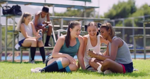 Friends Looking Phone Sports Field Group Female Athletes Sitting Relaxing — Stockvideo