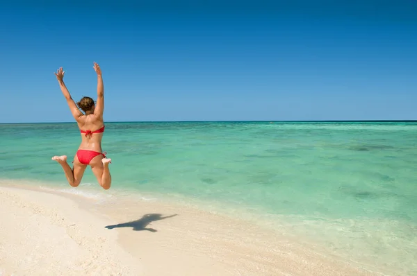 Shot of a woman jumping in excitement while on holiday.