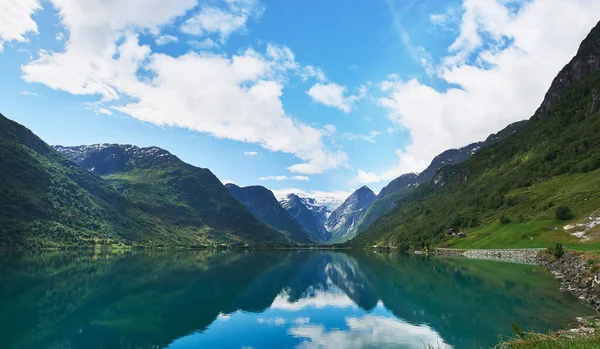 Majestic beautiful fjord landscape in Norway Fjord lake mountain snow water reflection glacial valley.