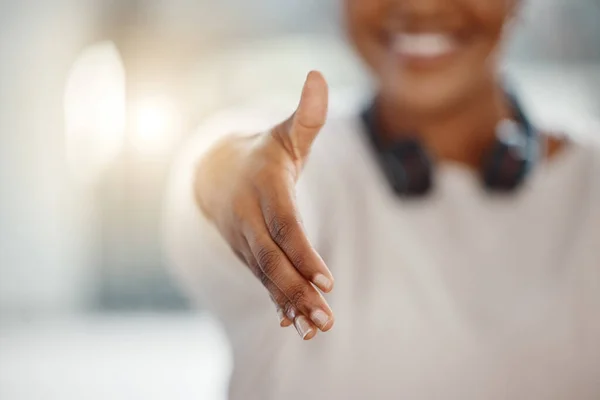 Closeup of one african american businesswoman extending hand forward to greet and welcome with handshake. Networking and meeting for interview to agree on deal or offer. Collaborating on negotiation