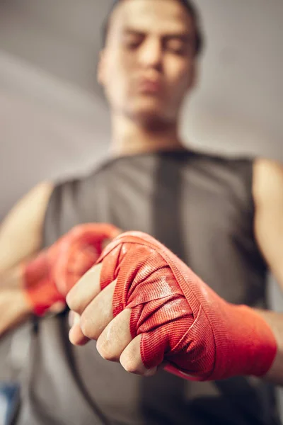 Closeup on hands of boxer with chalk on bandages. Hands of mma fighter ready for combat. Strong athlete with powder on bandage for boxing. Ready to throw a punch. Ready for boxing practice.